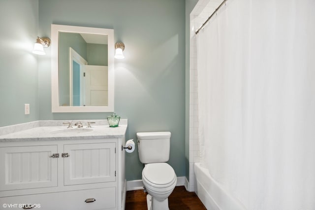 full bathroom with hardwood / wood-style flooring, shower / bath combo with shower curtain, vanity, and toilet