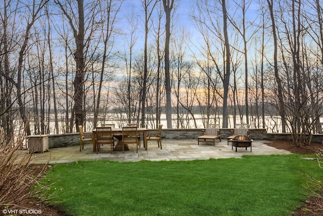 view of home's community with a lawn, an outdoor fire pit, and a patio