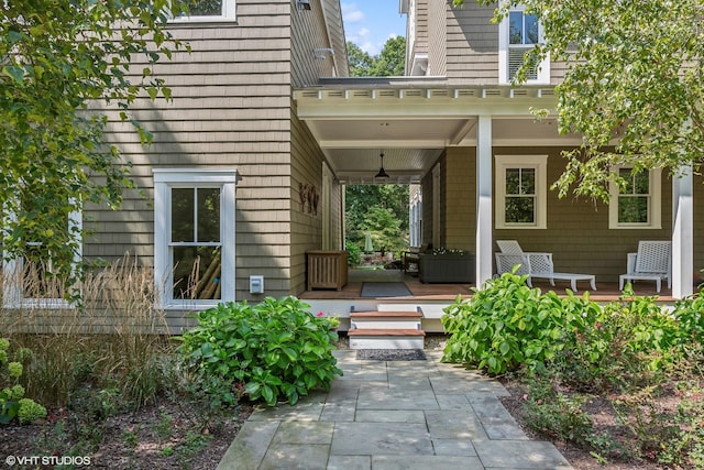 view of exterior entry with a porch