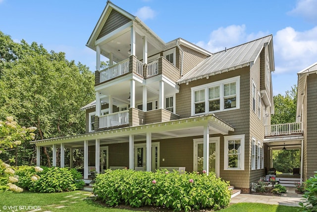 view of front of property featuring a balcony and covered porch