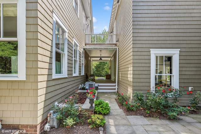 view of side of home featuring a balcony