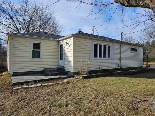 rear view of house with a yard