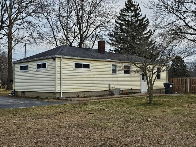 view of property exterior with a lawn