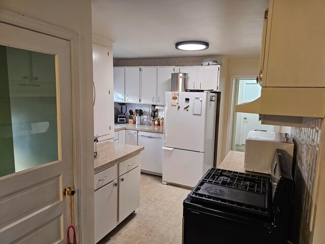 kitchen featuring white appliances, white cabinets, backsplash, and light tile flooring