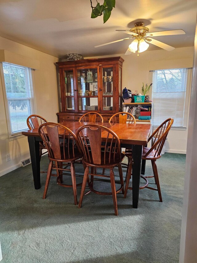 dining space with carpet flooring and ceiling fan