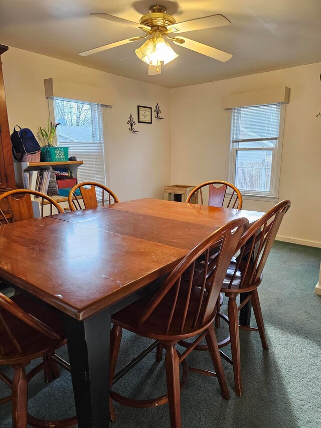 carpeted dining space featuring ceiling fan