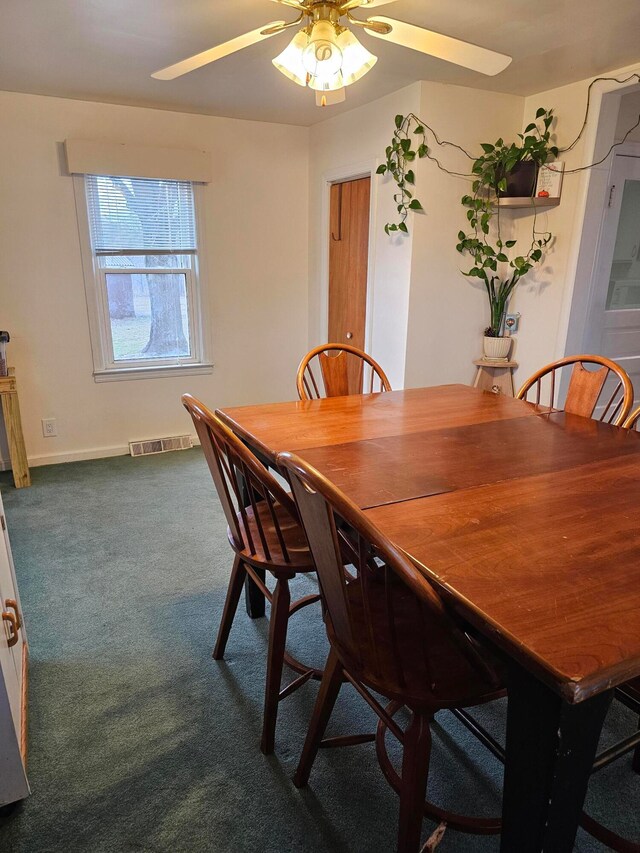 carpeted dining space featuring ceiling fan