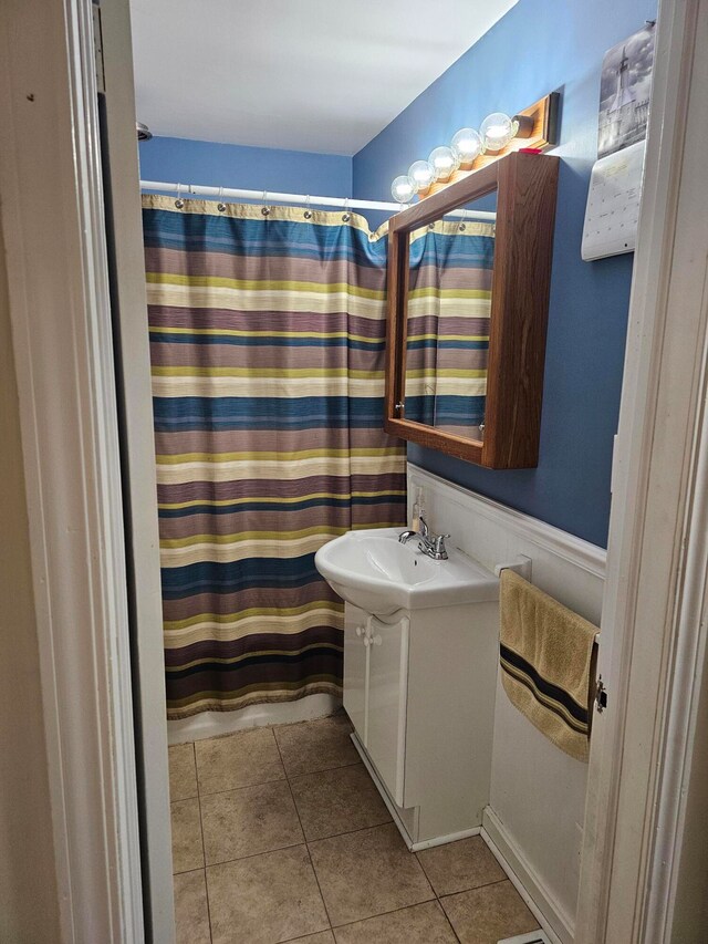 bathroom with tile flooring and vanity