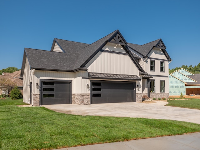 view of front of house featuring a front yard and a garage