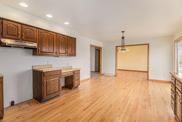 kitchen featuring hanging light fixtures and light wood-type flooring