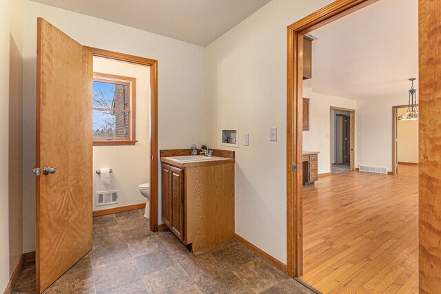 interior space featuring toilet, tile flooring, and vanity