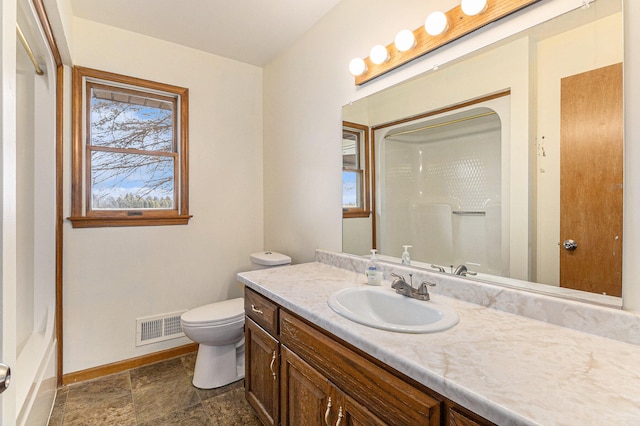 bathroom featuring vanity with extensive cabinet space, toilet, and tile floors