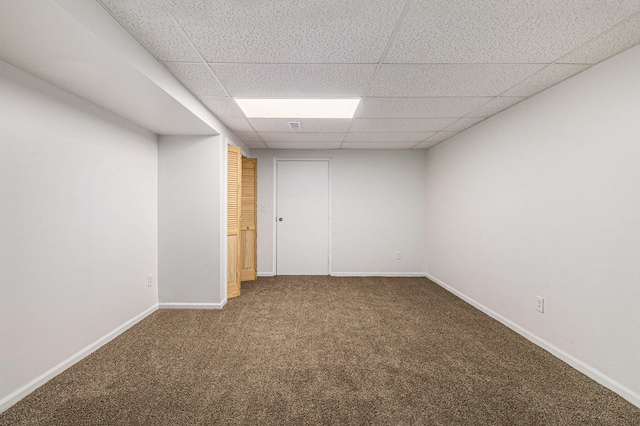 unfurnished room with carpet floors and a paneled ceiling