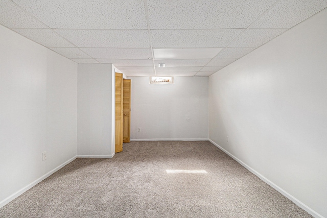 unfurnished room with carpet and a paneled ceiling