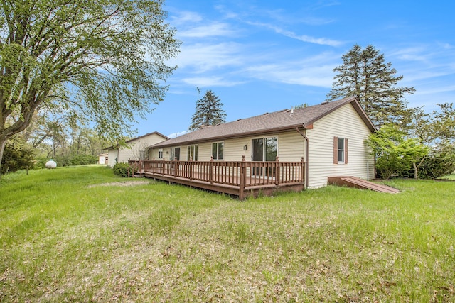 rear view of house featuring a yard and a wooden deck