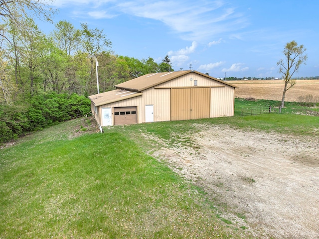 view of shed / structure featuring a lawn and a rural view