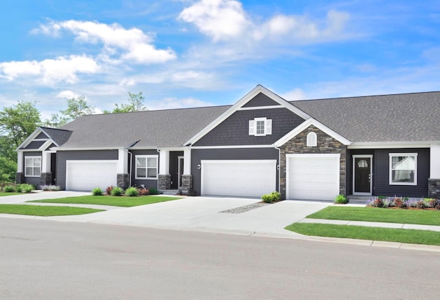 craftsman-style home with a front lawn and a garage