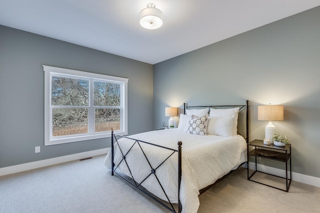 bedroom featuring light colored carpet