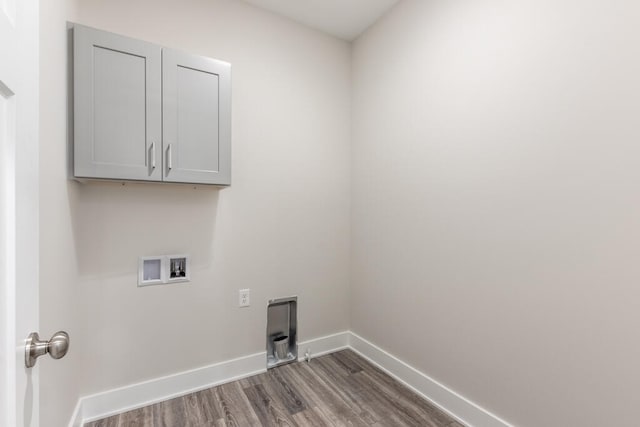 laundry area with hookup for a washing machine, cabinets, and dark hardwood / wood-style floors