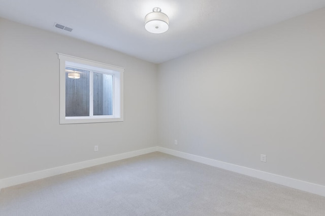 empty room featuring light colored carpet