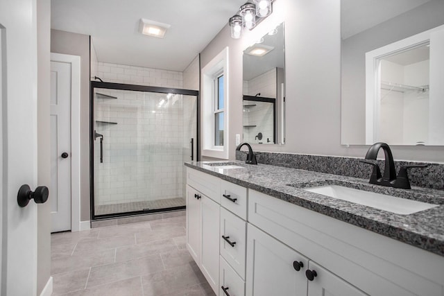 bathroom featuring vanity, an enclosed shower, and tile patterned flooring