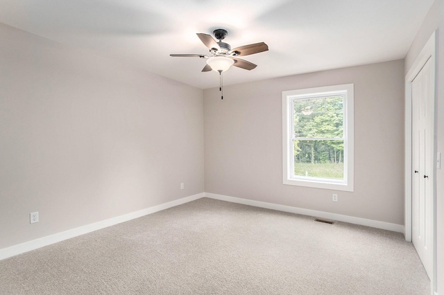 carpeted empty room with ceiling fan