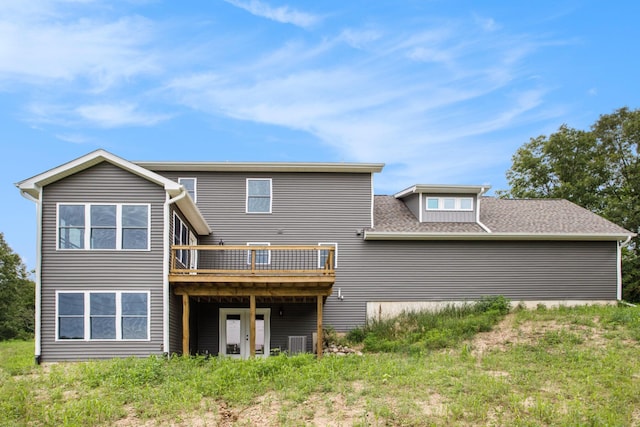 rear view of house featuring a wooden deck and central air condition unit