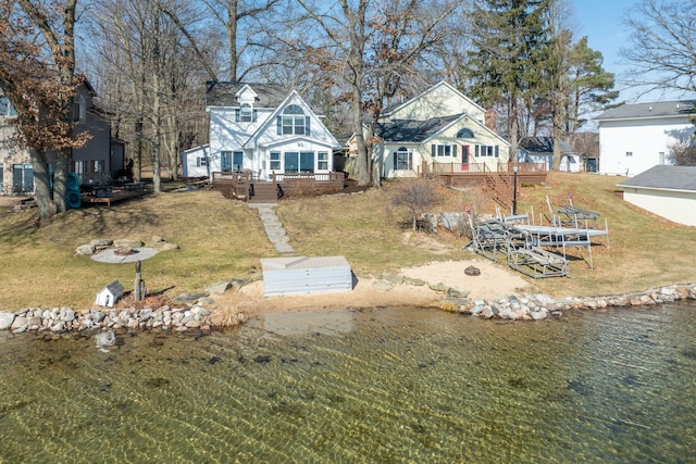 exterior space with a front yard and a deck with water view