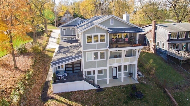 back of house with a patio and a balcony