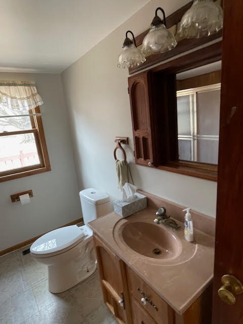 bathroom with large vanity, tile floors, and toilet