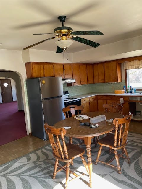 tiled dining space featuring ceiling fan