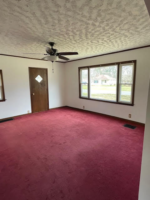 carpeted empty room with ceiling fan