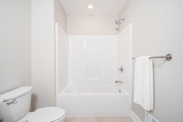 bathroom with toilet and shower / bath combination