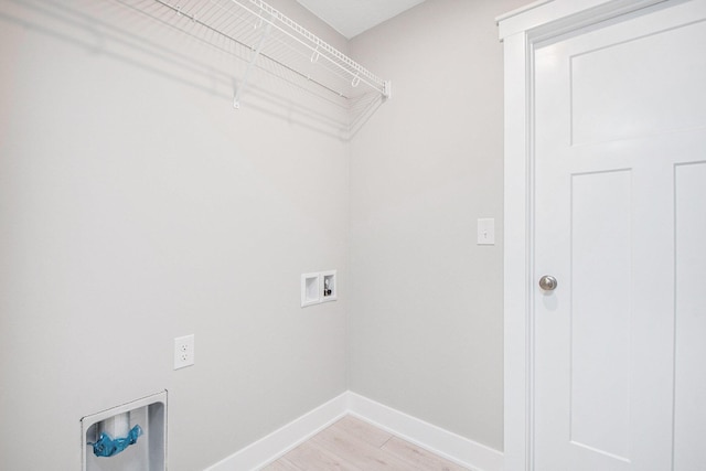 laundry area featuring washer hookup and light hardwood / wood-style floors