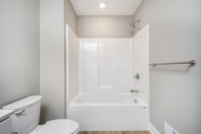 full bathroom featuring shower / bath combination, vanity, hardwood / wood-style floors, and toilet