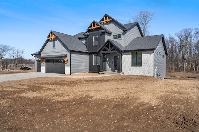 view of front of home with brick siding, board and batten siding, a shingled roof, concrete driveway, and a garage