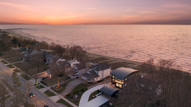 aerial view at dusk with a water view