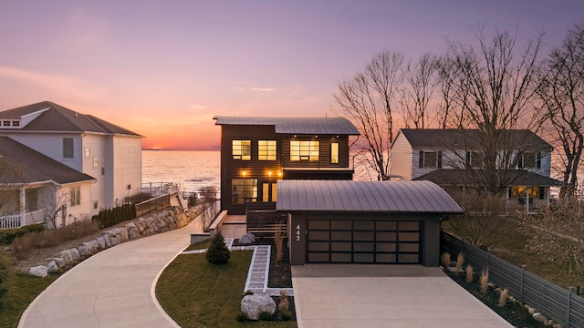 view of front of property featuring a water view and a garage