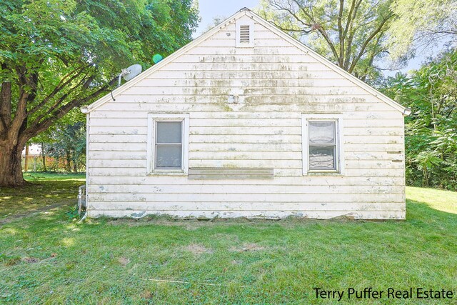 view of property exterior with a lawn