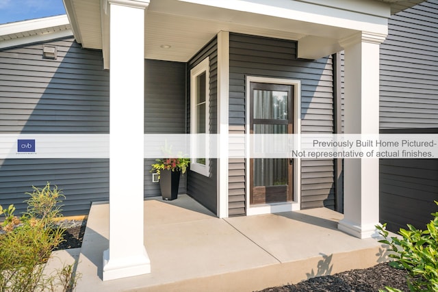 view of exterior entry featuring covered porch