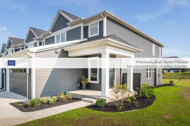 view of front of property with a front yard and a garage