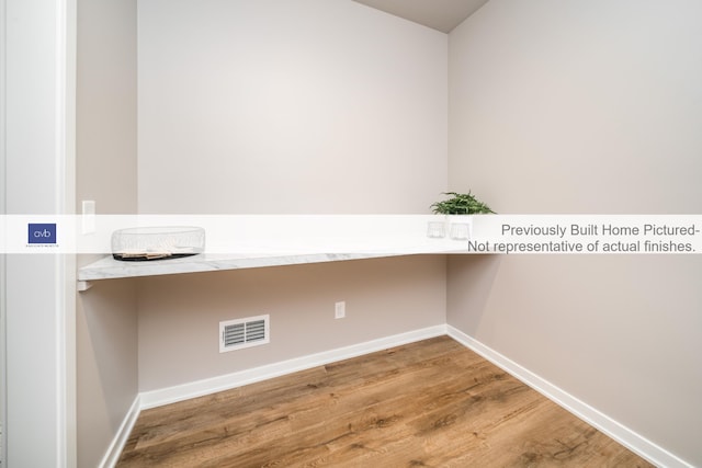 laundry area featuring wood-type flooring