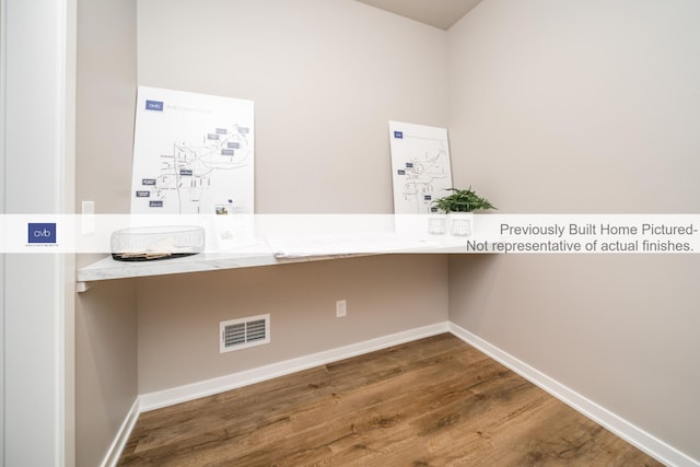 clothes washing area featuring wood-type flooring