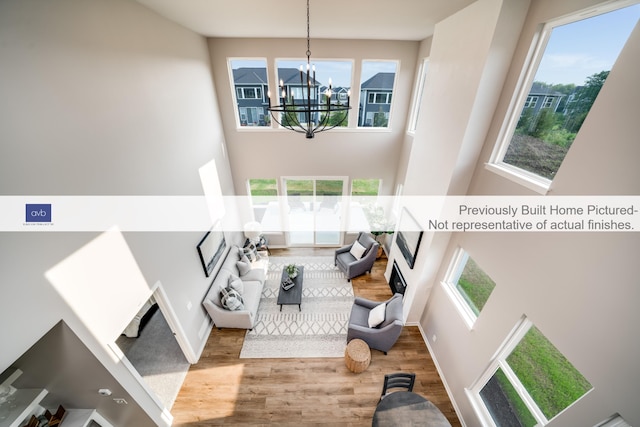 interior space with a chandelier, hardwood / wood-style flooring, and plenty of natural light