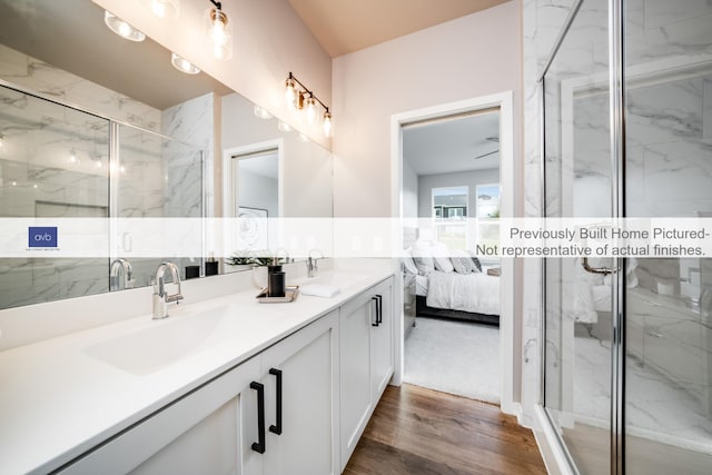 bathroom with vanity, hardwood / wood-style flooring, and walk in shower