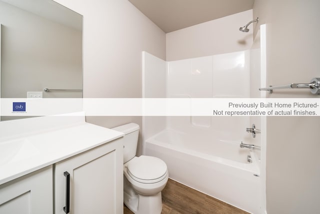 full bathroom with hardwood / wood-style floors, vanity, toilet, and tub / shower combination