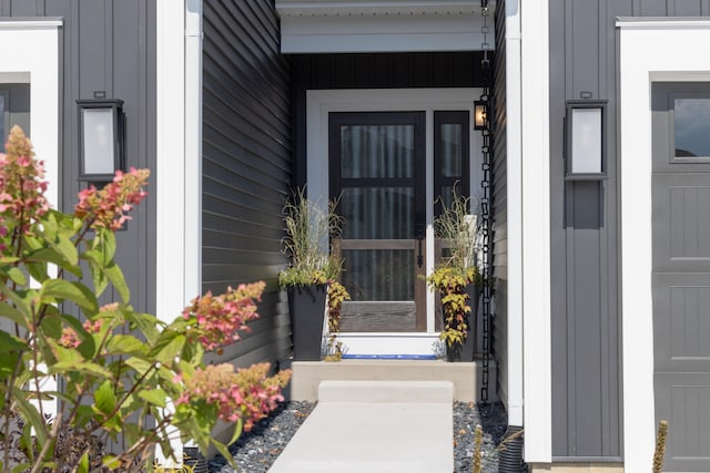 view of exterior entry with a garage