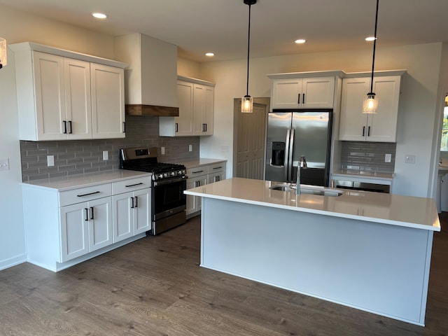 kitchen featuring dark wood-type flooring, white cabinets, decorative light fixtures, and appliances with stainless steel finishes