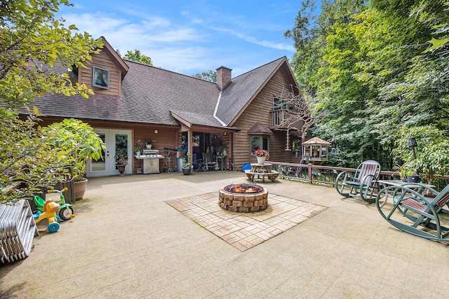 view of patio / terrace featuring area for grilling, french doors, and an outdoor fire pit