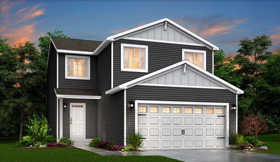 view of front of property with a lawn and a garage